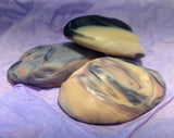 Marbled soap bars on a purple fabric background